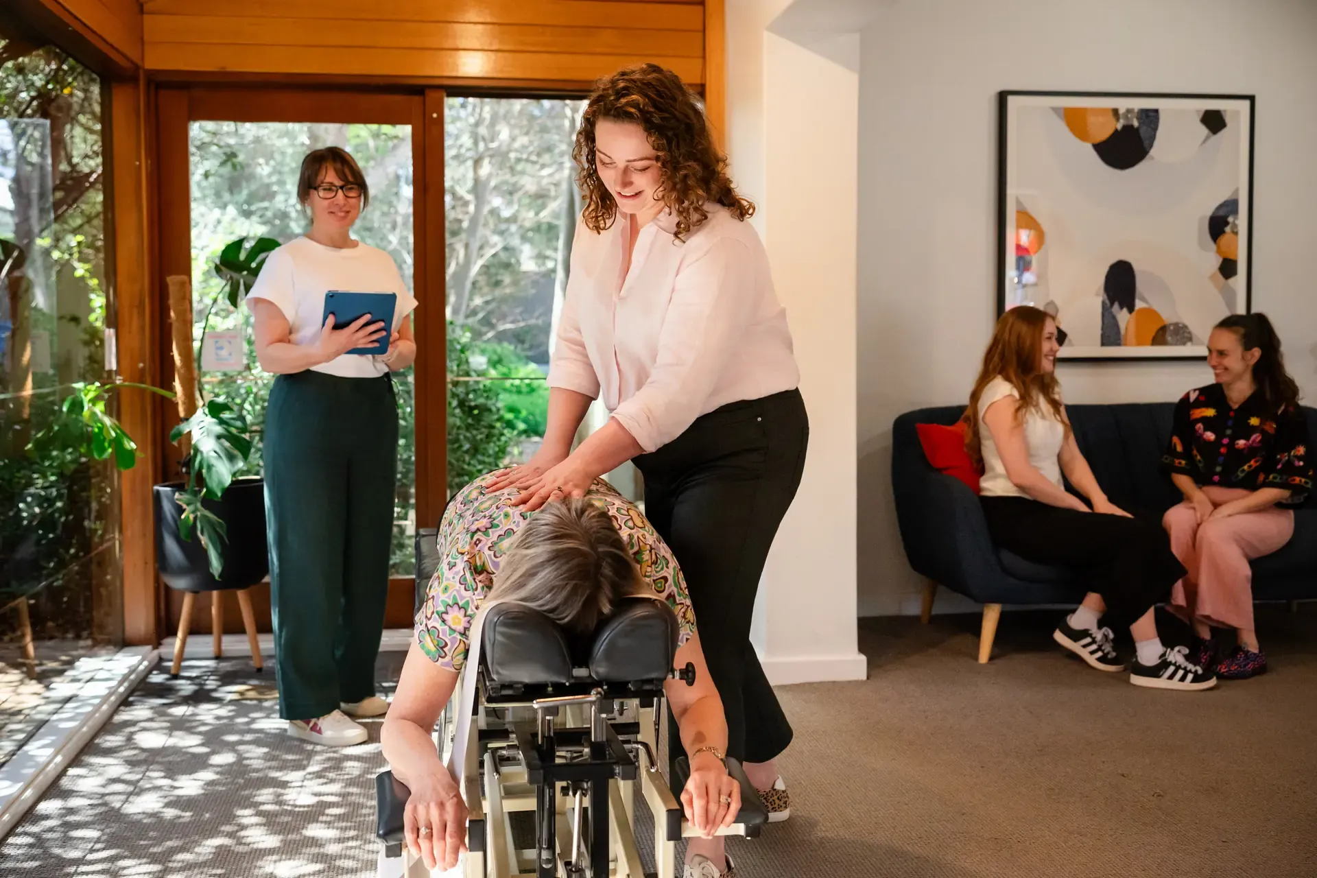 Dr Harriet Walker adjusting in the open plan practice at The Chiro Crew in Kingswood