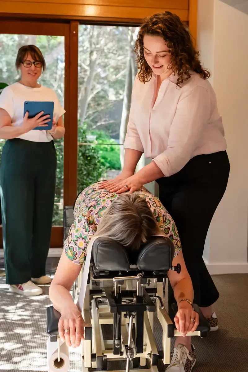 Dr Harriet Walker with a person seated on the table at The Chiro Crew in Kingswood