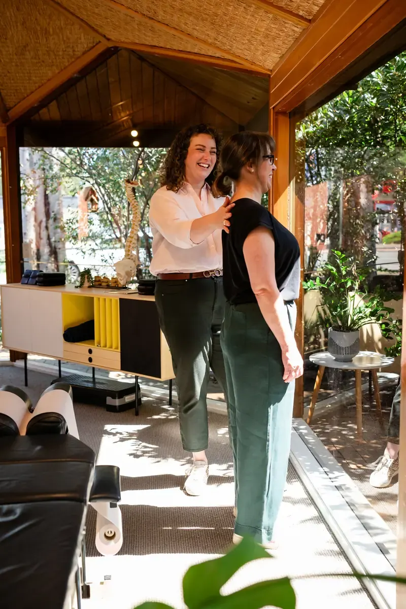 Dr Harriet Walker checking a person's standing posture at The Chiro Crew in Kingswood