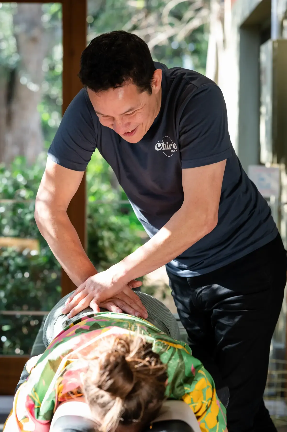 Dr Patrick Sims adjusting a person's lower back at The Chiro Crew in Kingswood