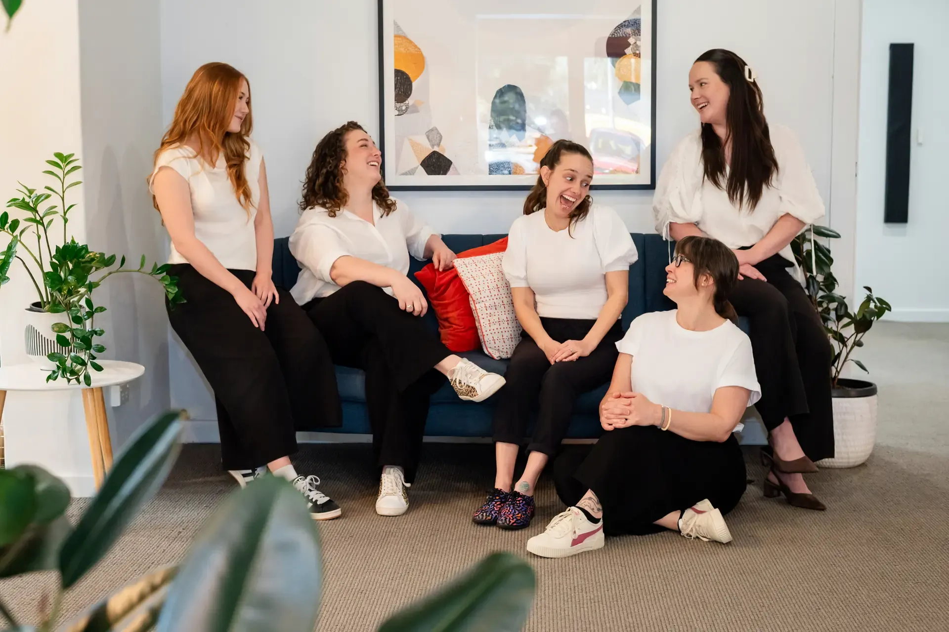 The Chiro Crew team relaxing together on the lounge at The Chiro Crew in Kingswood