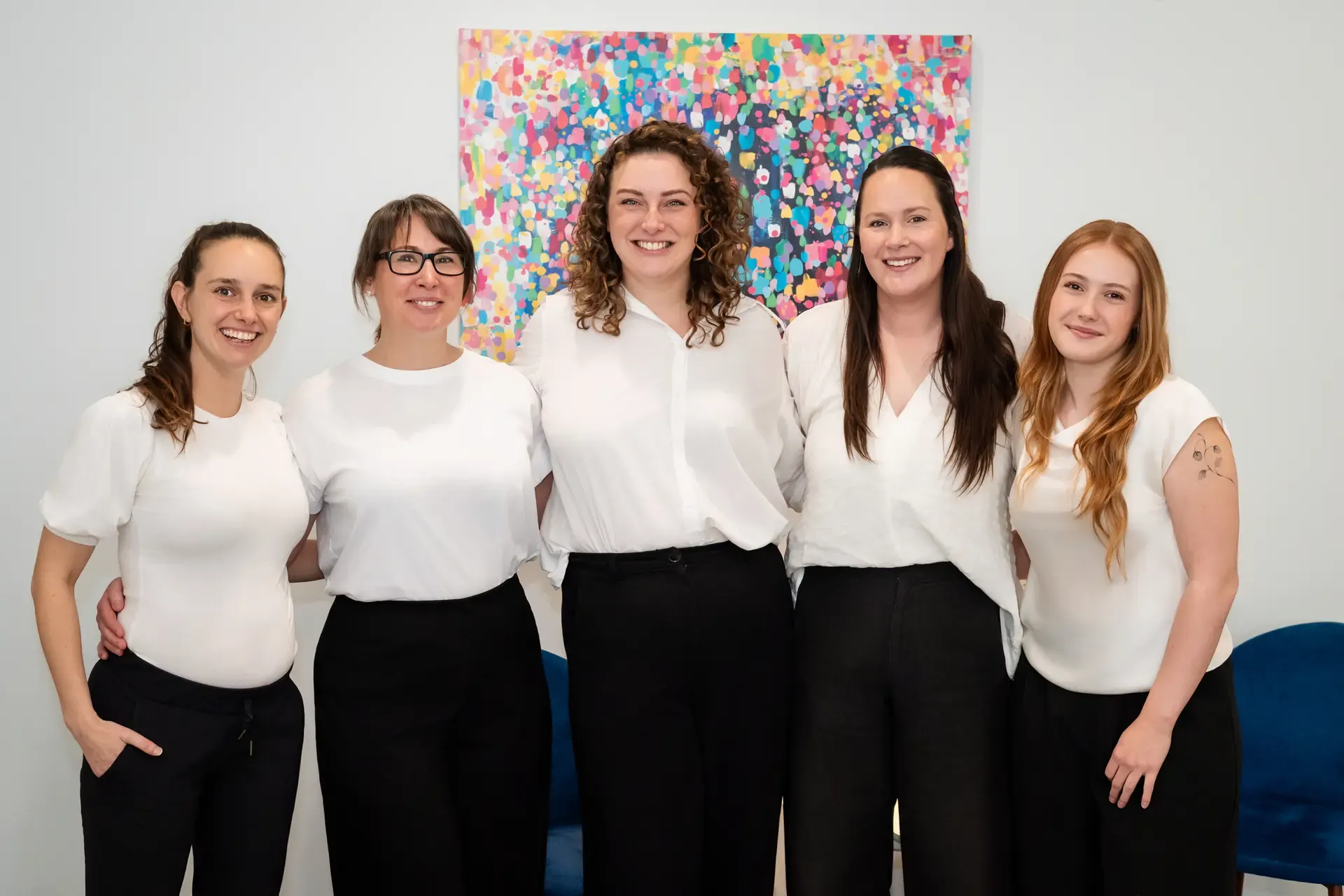 The Chiro Crew team standing together in the practice at The Chiro Crew in Kingswood